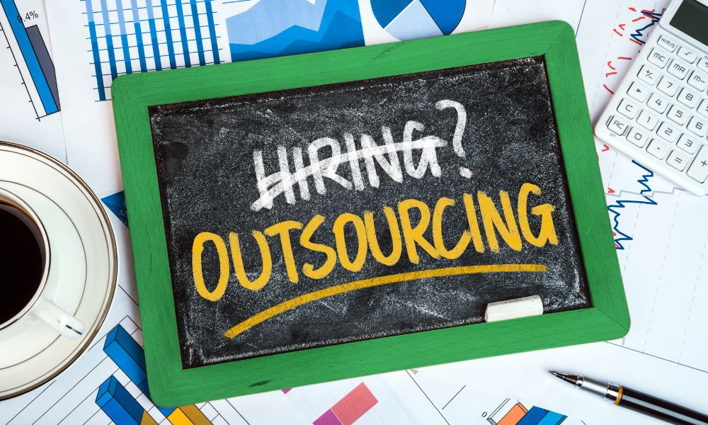 Chalk board with outsourcing written on it