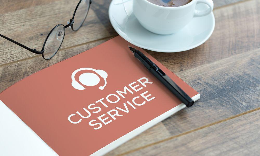 Customer service guide on a table with a cup of coffee and glasses.