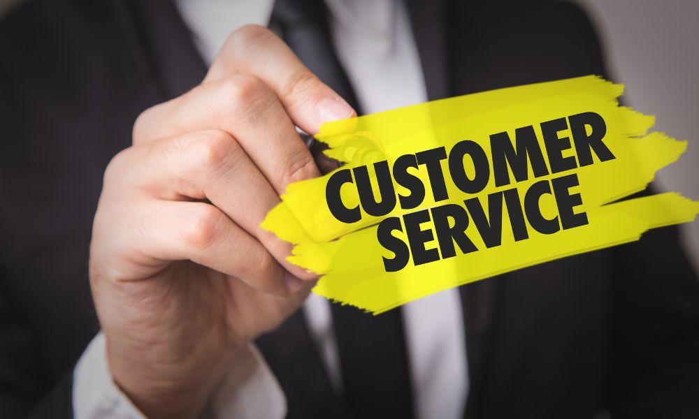 Man highlighting the words Customer Service written on glass.