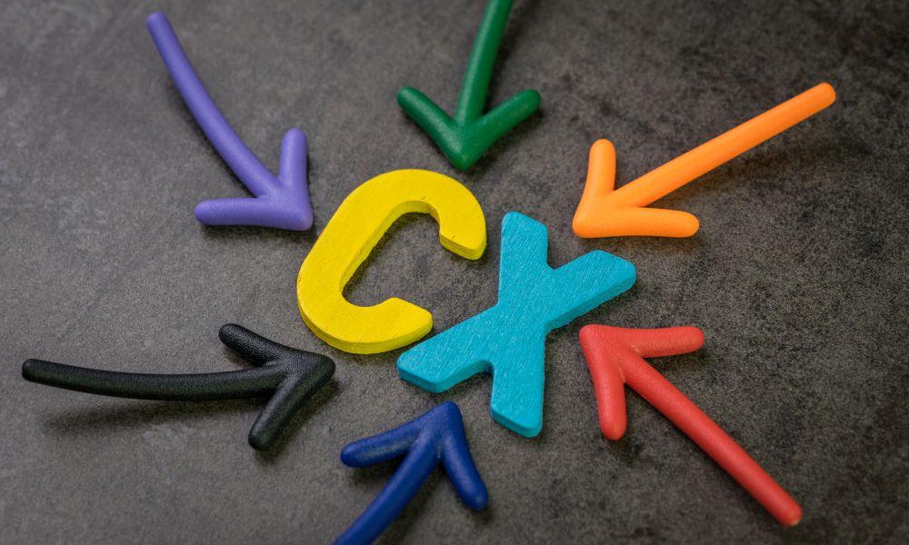 Colourful letters CX with arrows pointing towards it illustrating the customer experience concept.
