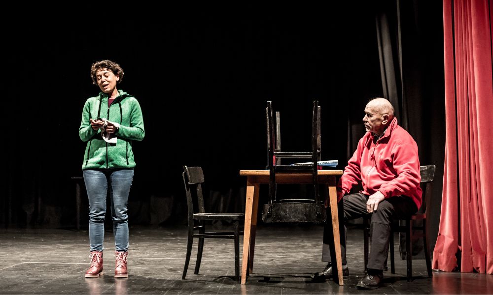 Male and female actors acting on a stage.