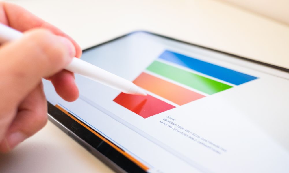 The stages of a sales funnel demonstrated on a tablet by a marketing manager.