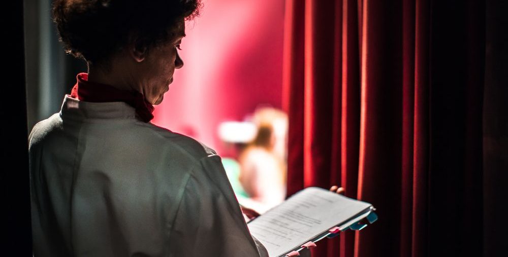 An actor memorising lines backstage.