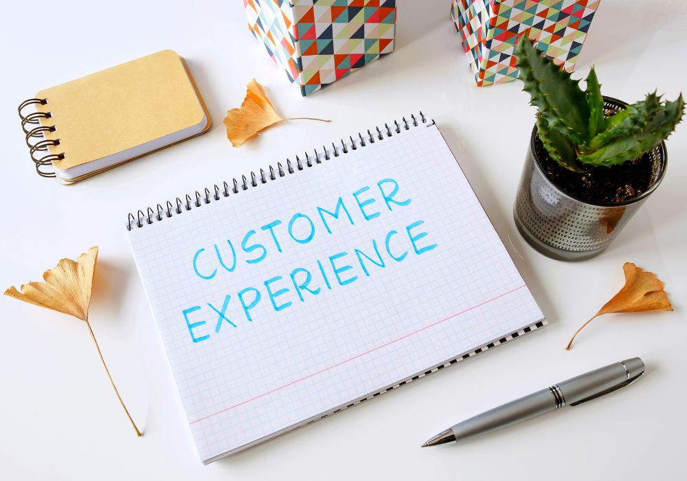 The words customer experience written on a notepad.