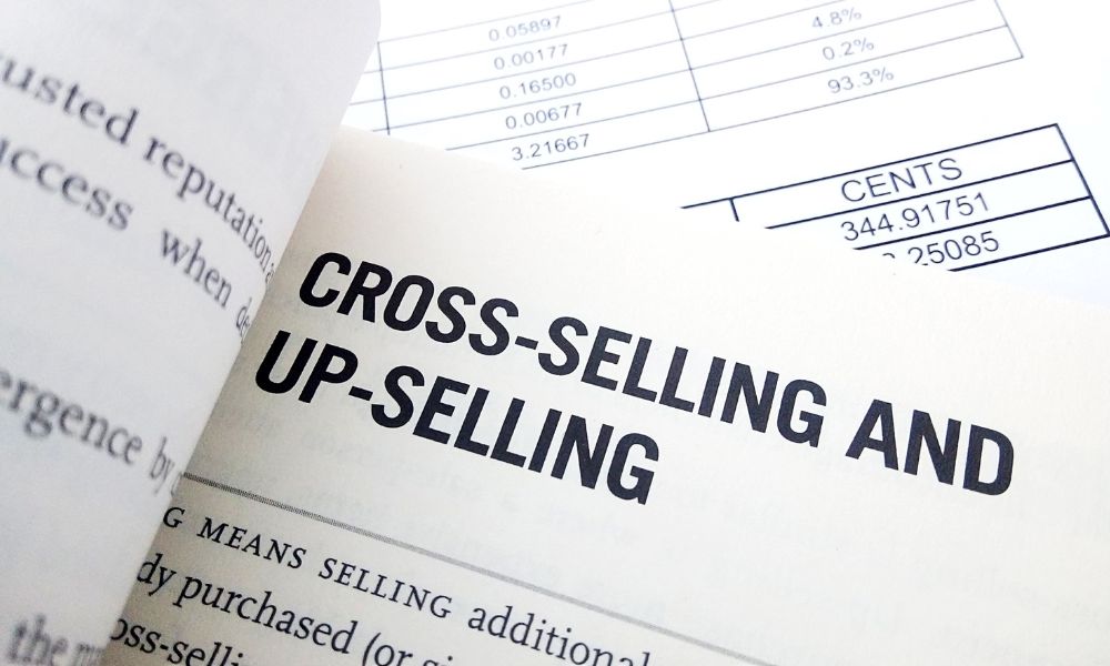 A handbook opened at the page that defines cross-selling.
