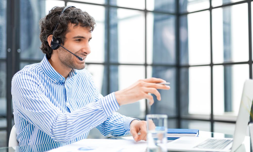 An agent using a cold calling script as a guideline for a sales call.
