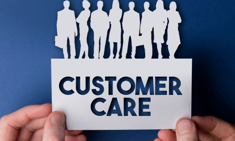 A paper cut-out with the words Customer Care and business people on top.