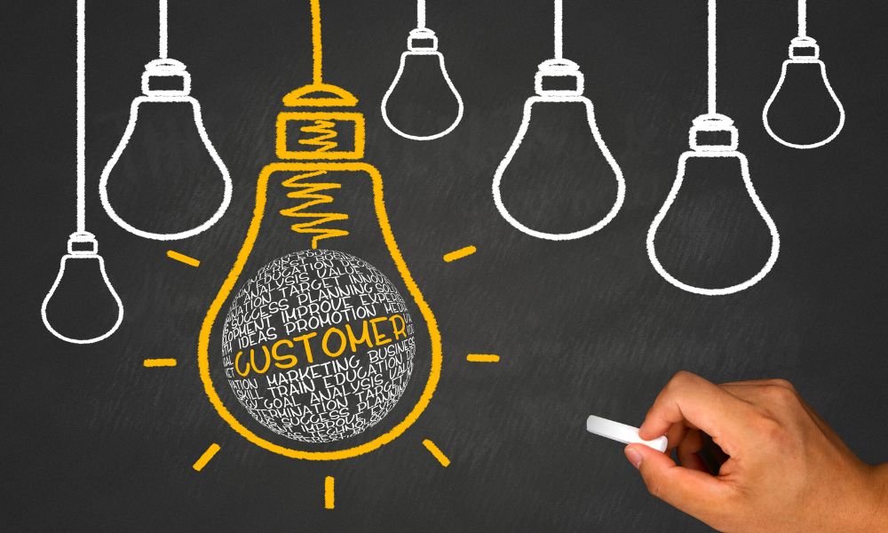 Light bulbs drawn on a chalkboard with the word customer and related words written in the biggest light bulb.