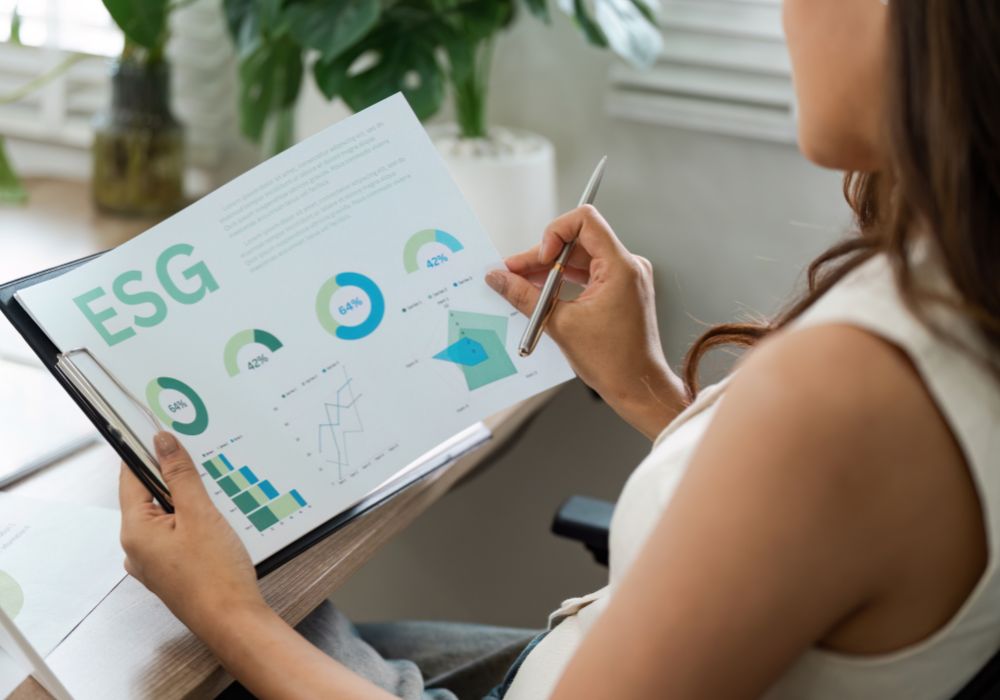 Woman analysing business ESG sustainability charts in an office setting.